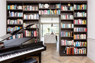 A bookshelf arranged within an archway