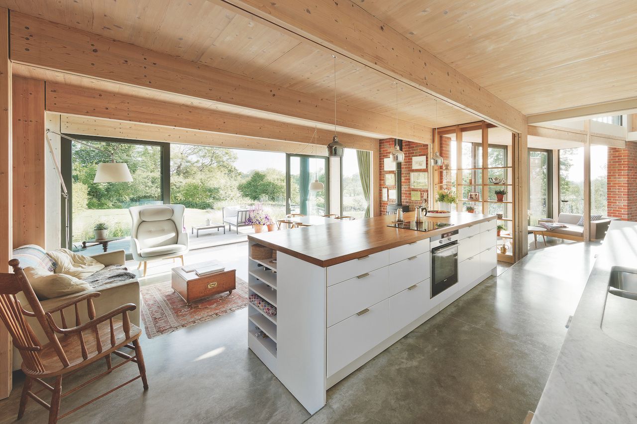open plan kitchen with view to garden and concrete floor