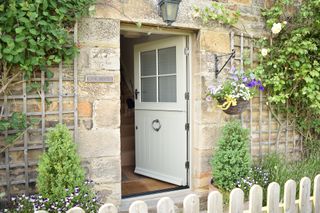 green stable door in stone cottage