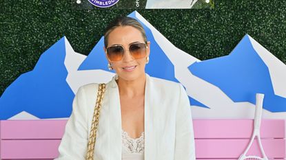 Rachel Stevens in big sunglasses and a white blazer