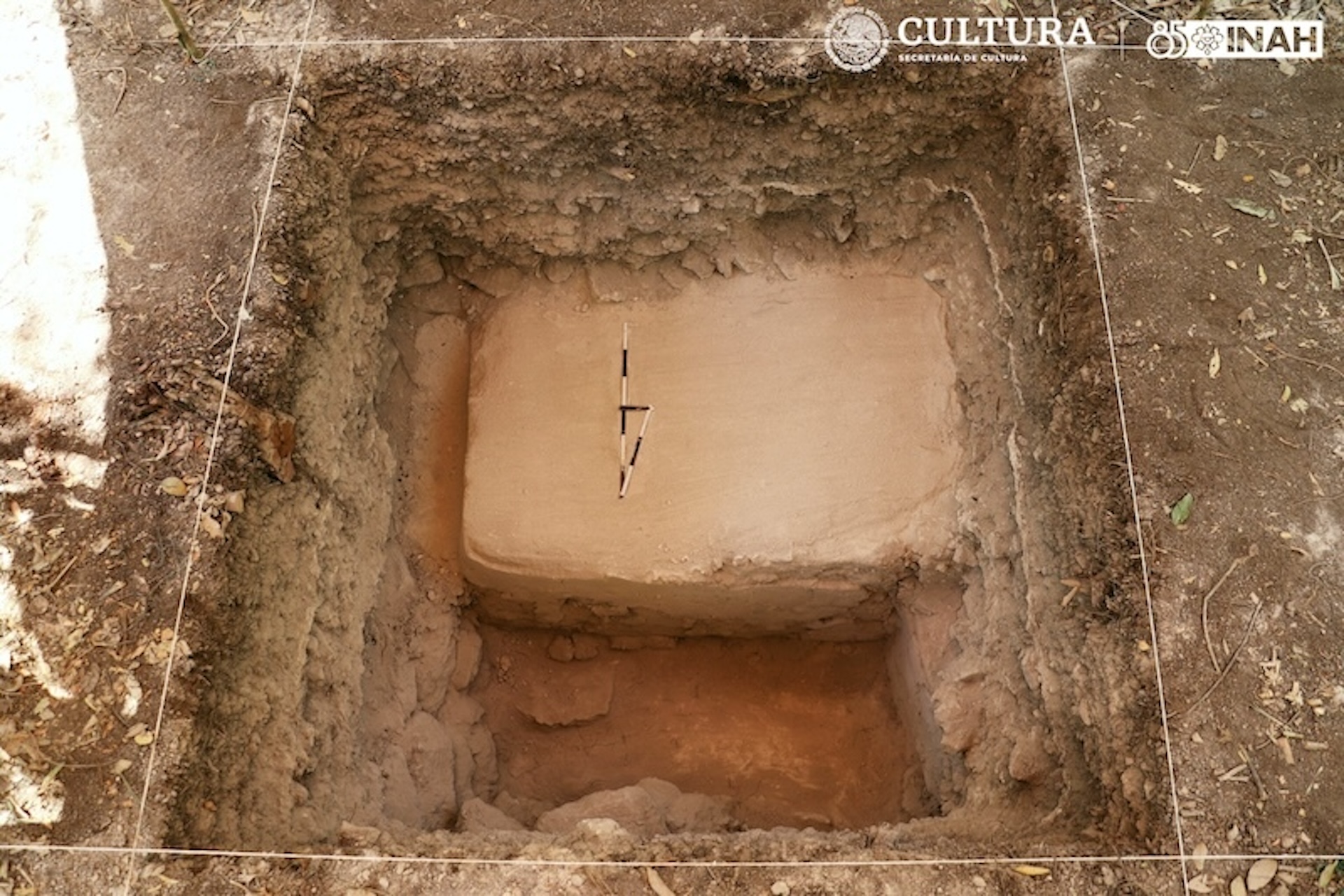 A rectangular hole excavated from the ground