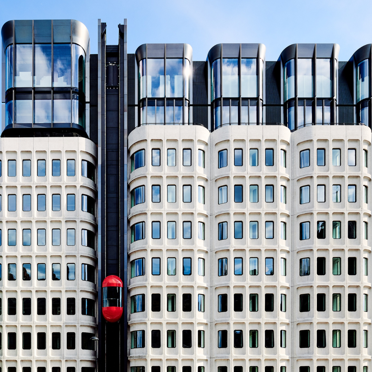 The hotel exterior with the red pill lift.