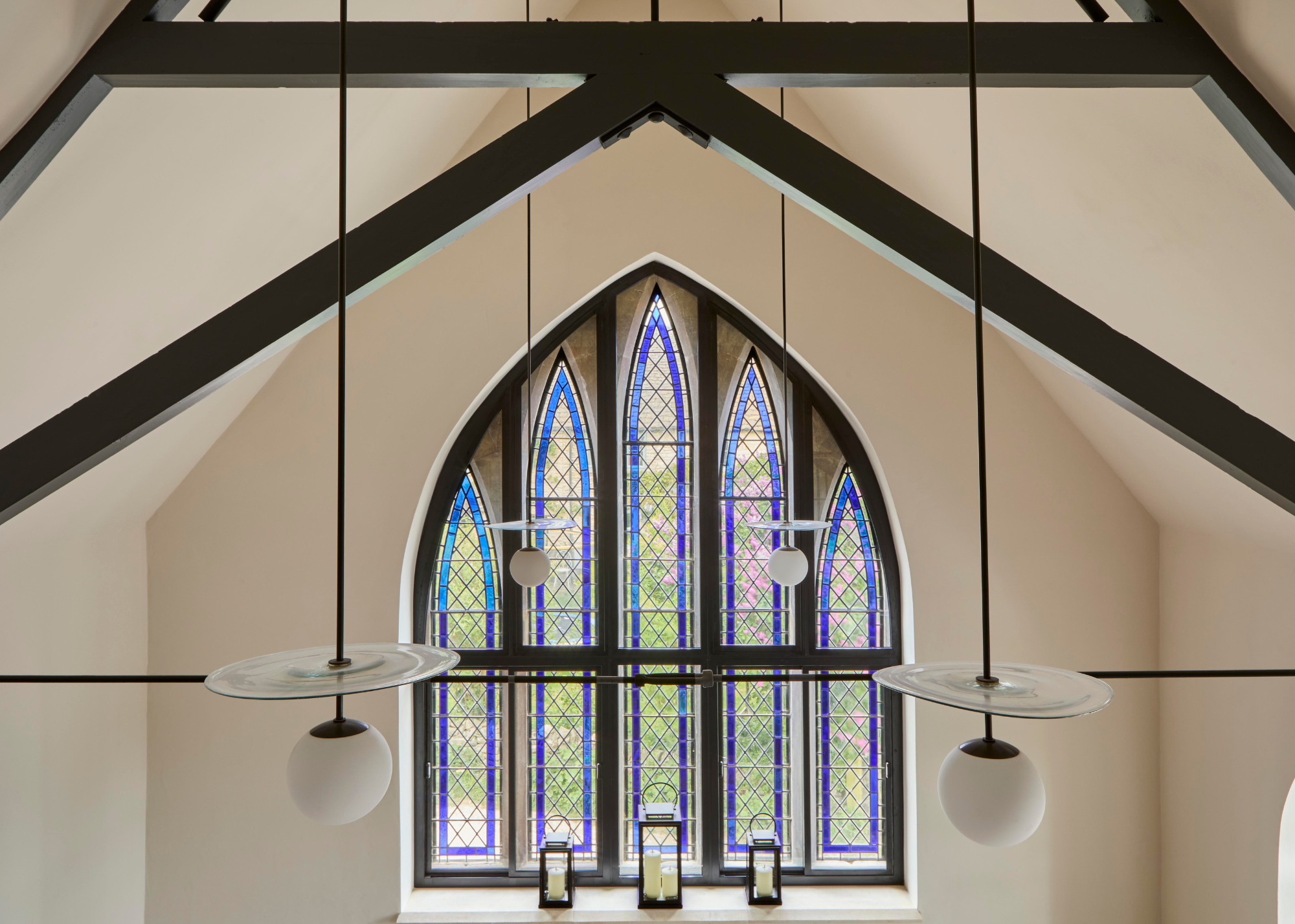converted chapels with large stained glass windows and a vaulted ceiling