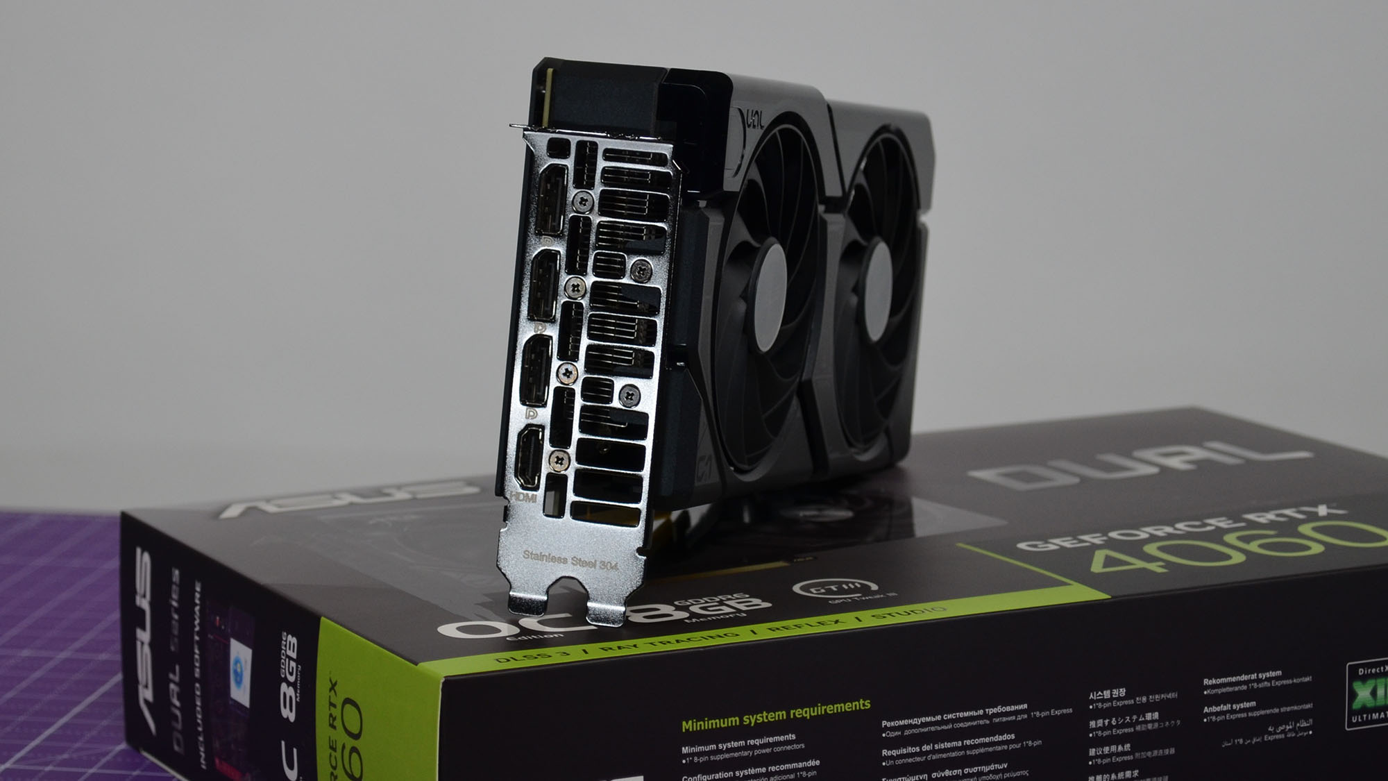 An Nvidia GeForce RTX 4060 on a table with its retail packaging