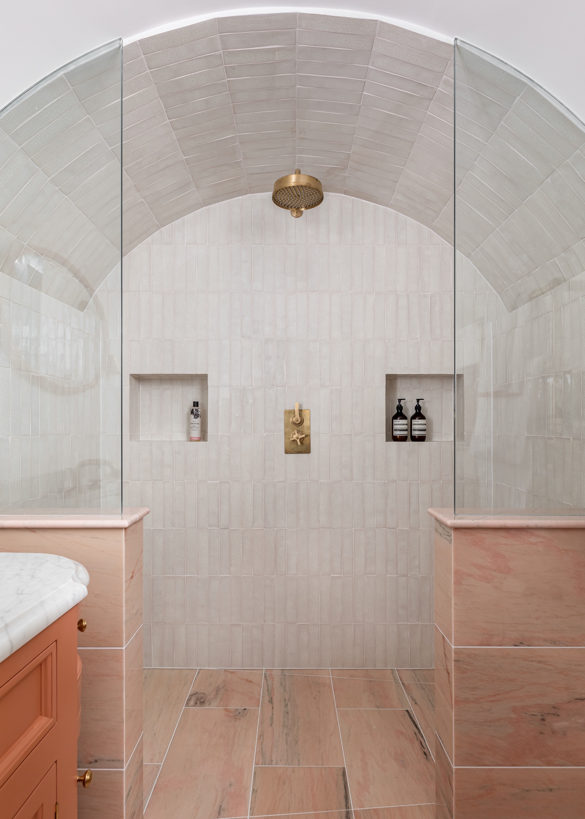 bathroom with white zellige tiles and wood effect floor tiles with brass finishes