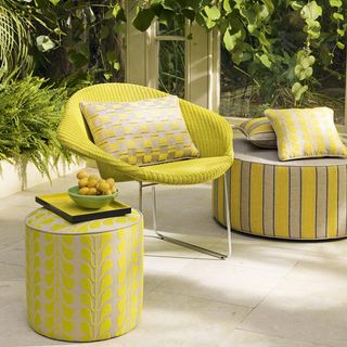 conservatory with yellow chair and cushion