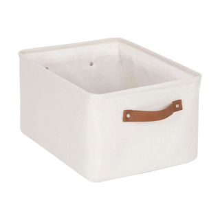 A white canvas storage basket with brown handles