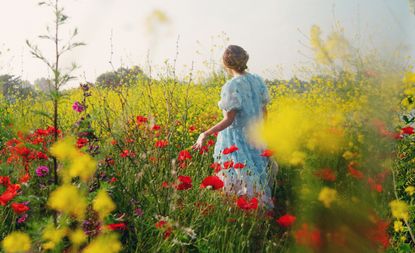 Rear View Of Woman Standing On Flowers Field Against Sky, Cottagecore trend