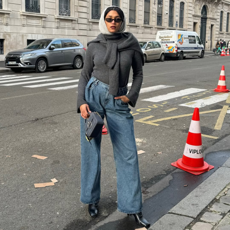 Influencer Lena Farl wearing a grey roll neck, wide-leg jeans and a knitted hood.