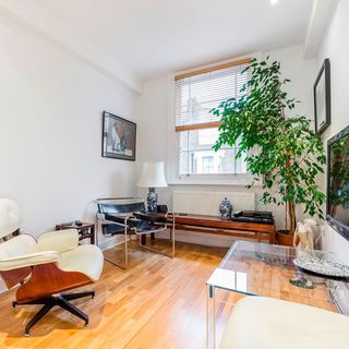 living room with white wall and lamp