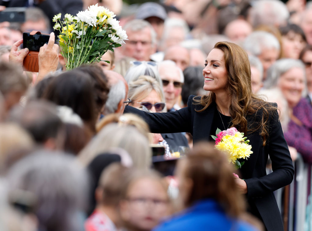 Catherine, Princess of Wales receives bouquets of flowers as she meets members of the public after viewing floral tributes left at the entrance to Sandringham House, the Norfolk estate of Queen Elizabeth II, on September 15, 2022 in Sandringham, England. The Prince and Princess of Wales are visiting Sandringham to view tributes to Queen Elizabeth II, who died at Balmoral Castle on September 8, 2022.