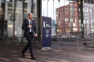 Prince William wears a suit as he leaves Ulster University and is booed by protestors