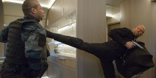 Jason Statham kicking a villain in Fate Of The Furious