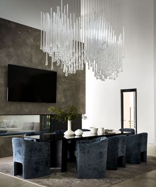 Dining room with stone feature wall and blue velvet chairs