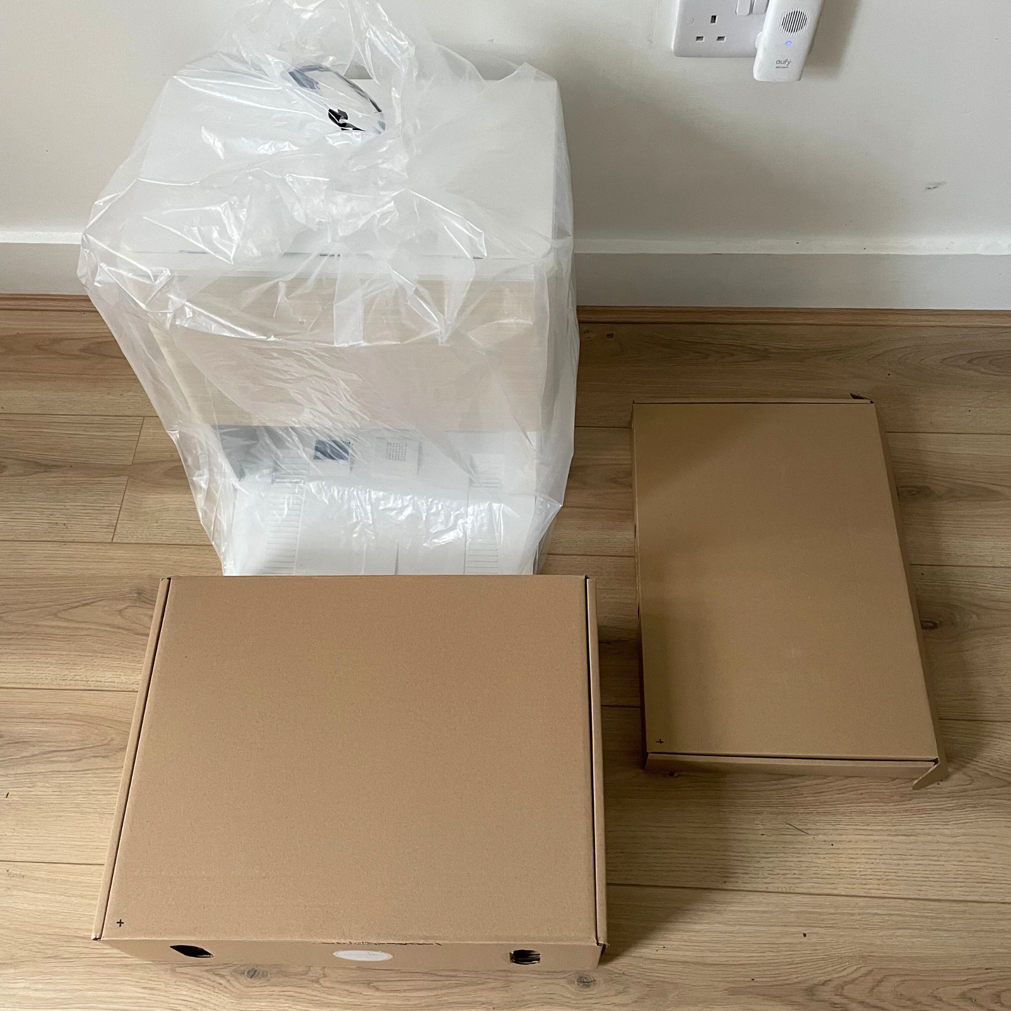 iRobot Roomba Max 705 Combo Robot Vacuum Cleaner and Mop components in packaging laid out on wood-effect flooring