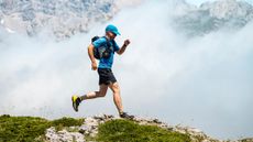 a photo of a man running with a hydration backpack