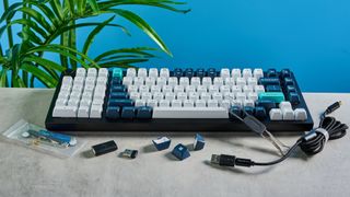 the keychron q12 max southpaw keyboard in navy blue with white and teal keycaps and red jupiter gateron switches