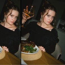 Ava Phillippe taking a photo at a table eating and drinking wine