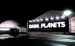 a black display board with the words DMM PLANETS written in white.