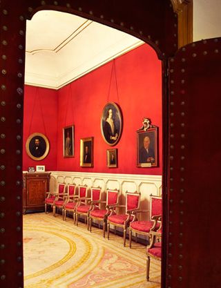Red room with red chairs along wall