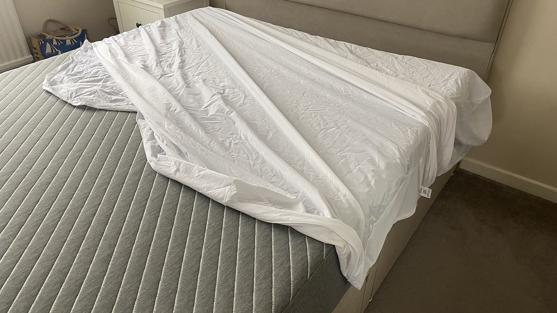 The Linenspa Mattress Encasement halfway on the mattress in or reviewer Ruth Jones' bedroom