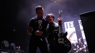 Mark Tremonti onstage with a young fan