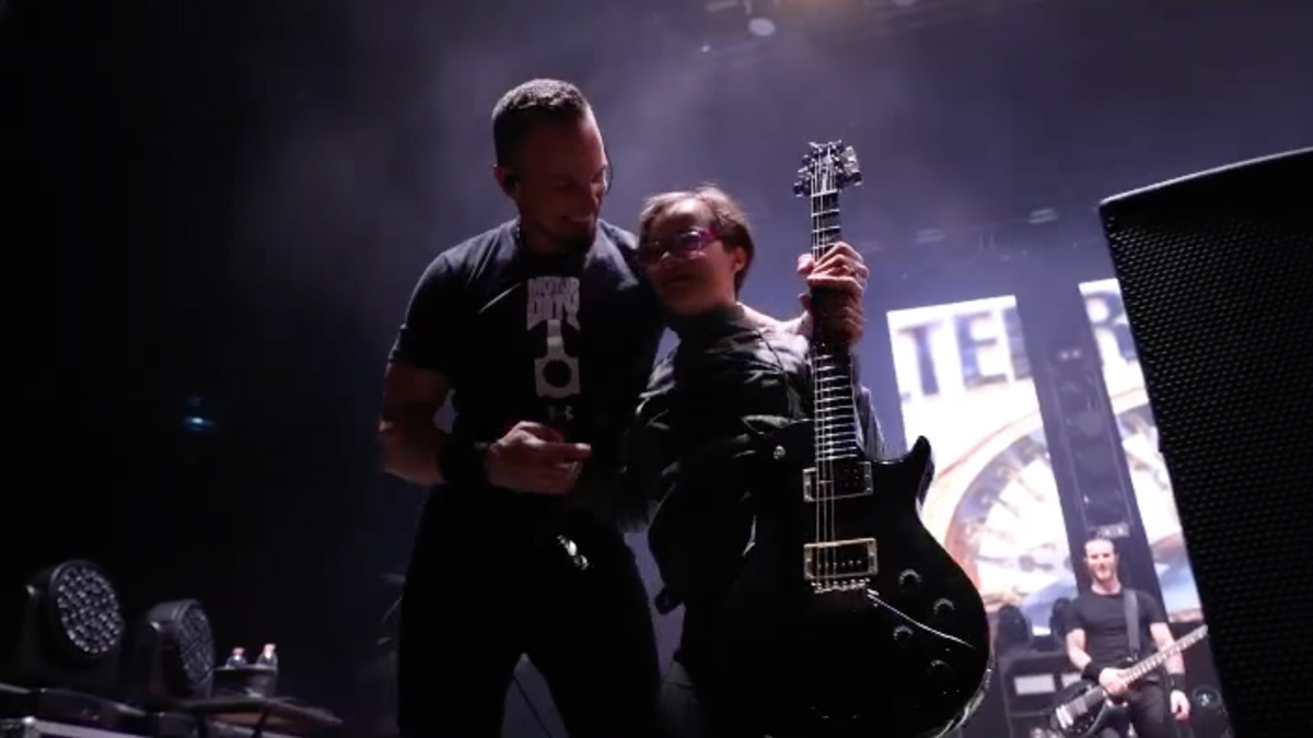 Mark Tremonti onstage with a young fan