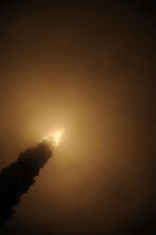 An Ariane 5 rocket carrying the European Space Agency's ATV-3 cargo ship Edoardo Amaldi disappears into clouds after a dazzling launch just after 12 a.m. EDT from Guiana Space Center in Kourou, French Guiana.