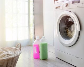 Washing machine with detergents and basket next to the washing machine