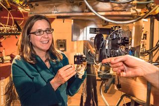 Shelley Wright, an Assistant Professor of Physics at the University of California, San Diego, led the development of the near-infrared optical SETI (NIROSETI) instrument. Wright holds a fiber that emits infrared light for calibration of the detectors.