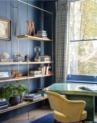 Home office design with green desk and blue walls