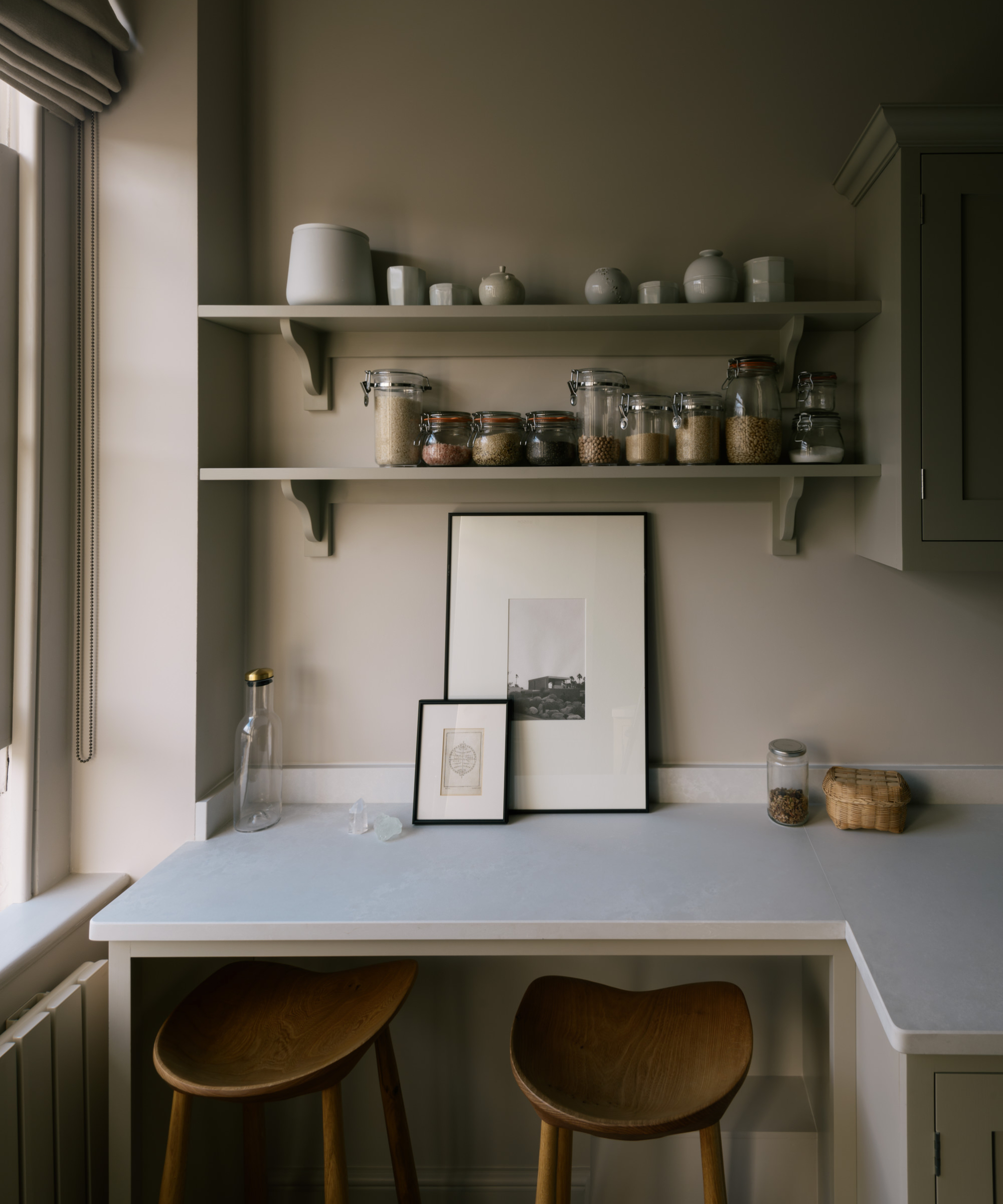 small shelf extended from kitchen unit with stools underneath