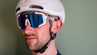 A man wearing a paor of scicon aeroscope sunglasses