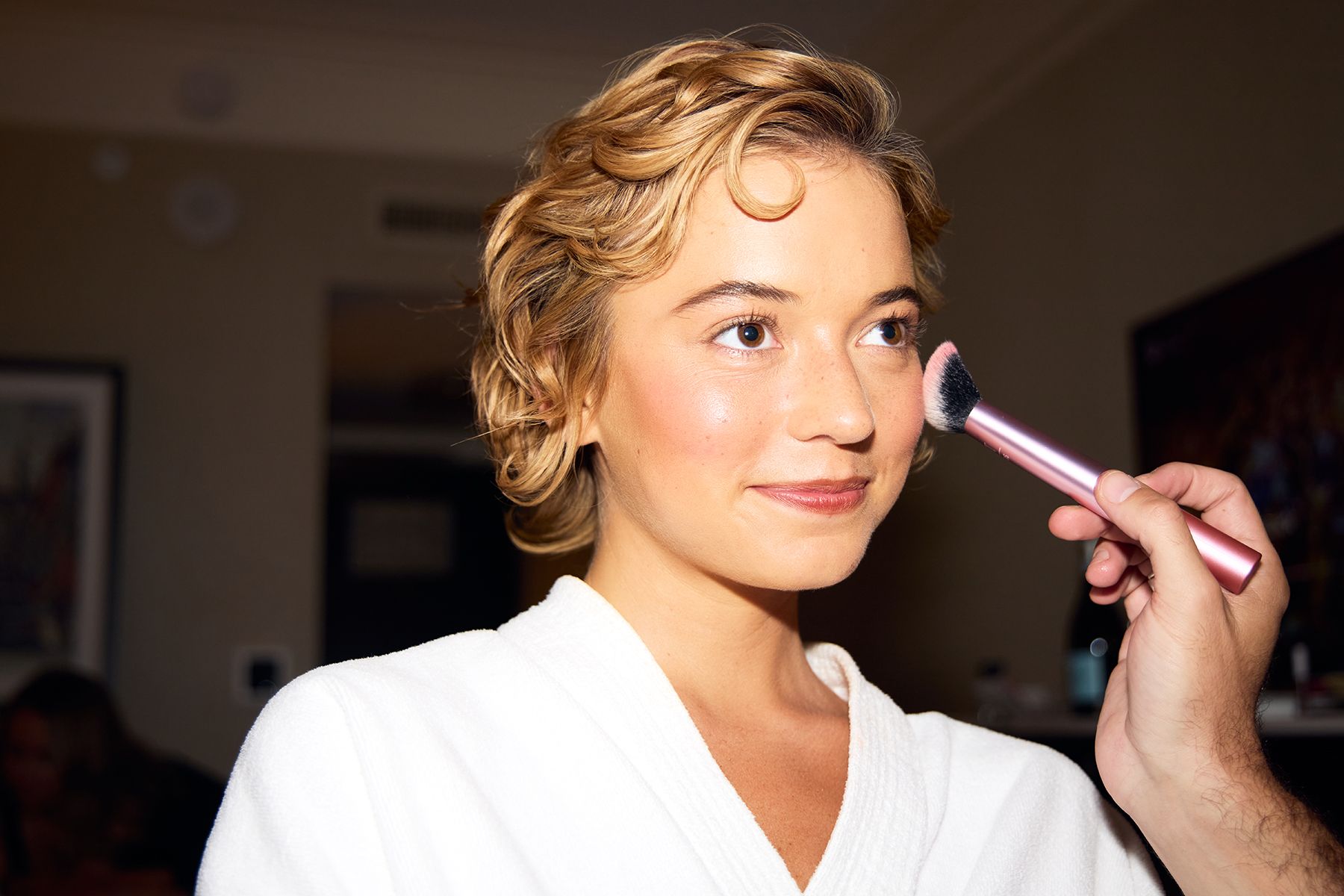 Makeup artist Ian Russell puts final blush touch-ups on Sophie Telegadis as she gets ready for her film premiere at TIFF.