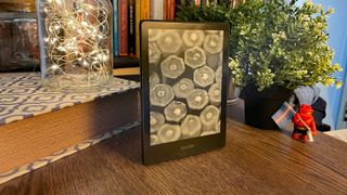 best kindle Kindle Paperwhite Signature Edition by a bookshelf