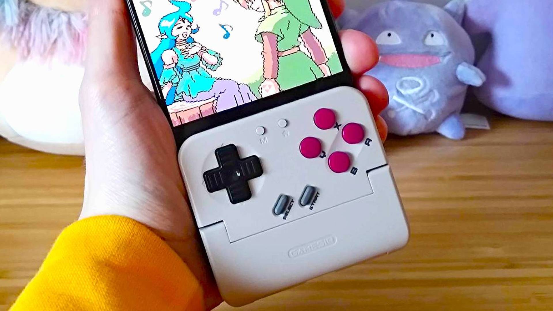 Close up of GameSir Pocket Taco with Zelda: Oracle of Ages cutscene of Link and Nayru on screen.