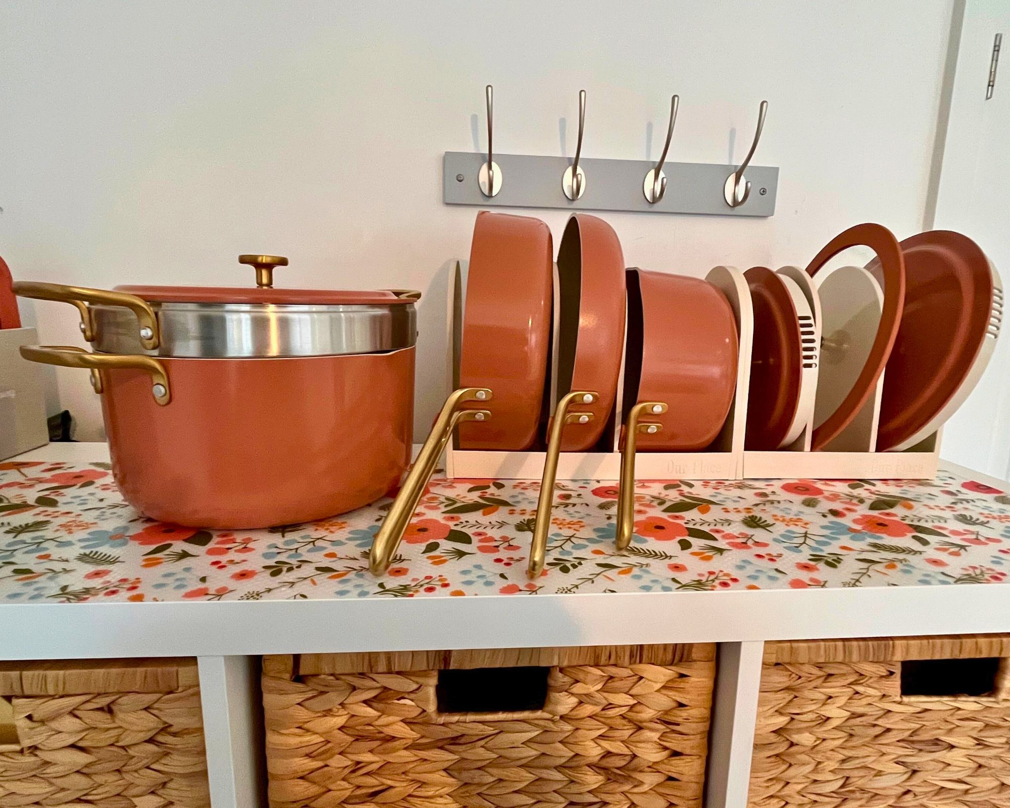 The Our Place 11-Piece Essentials Set sits snugly and neatly in its provided organizer, which is matte cream. The set is pictured here on top of my IKEA KALLAX cabinet, which has a silicone floral surface protector and wicker baskets