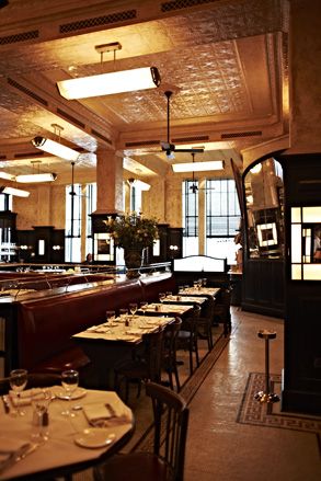 Balthazar restaurant with red leather banquette seating, high pressed ceilings and ochre colored walls