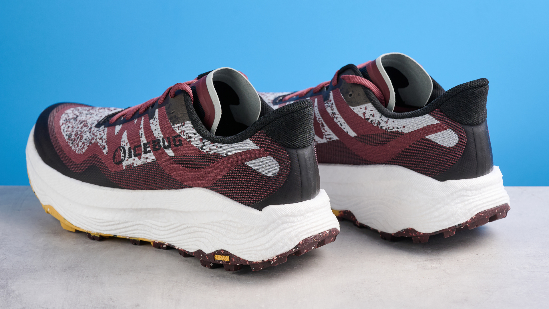the icebug j&amp;auml;rv rb9x trail running shoes in cherry and banana photographed against the tom's guide blue background