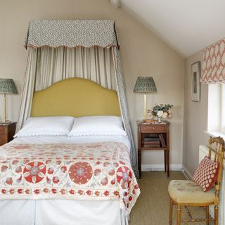grey bedroom with patterned curtains and bedspread