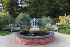 The pond with its millstone fountain and olive trees. Credit: Mimi Connolly