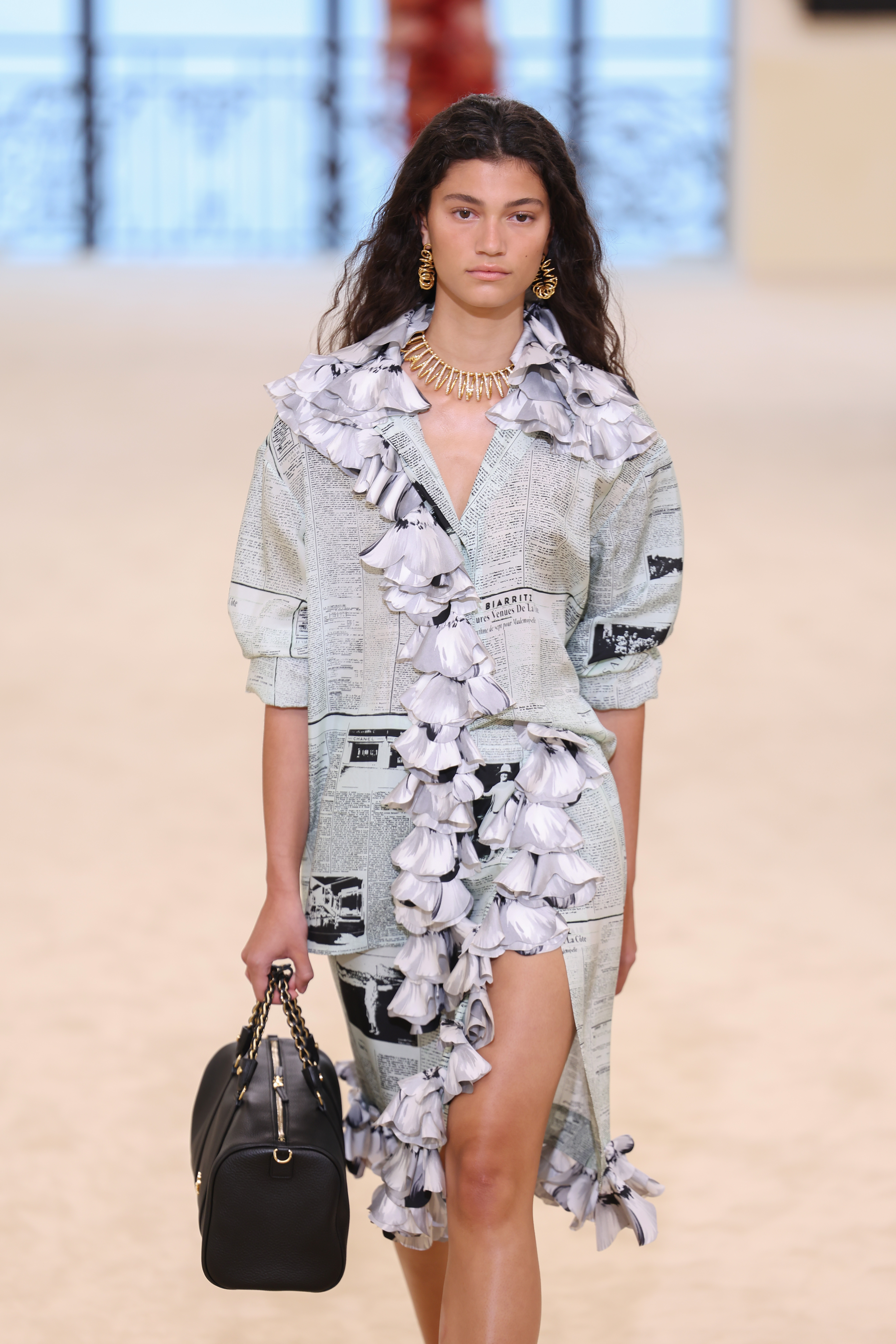 A model wore Chanel's newspaper-print dress on the Cruise 2027 runway
