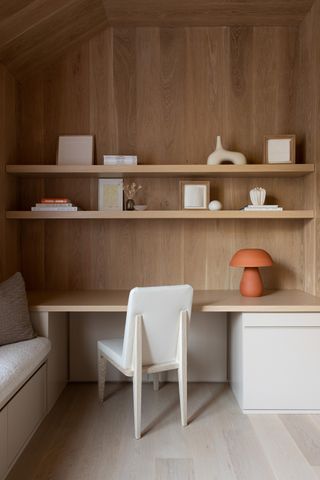 Minimalist bookshelf styling making use of wooden shelves in an office