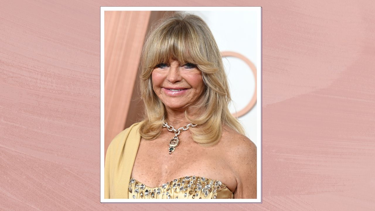 Goldie Hawn is pictured with a full fringe hairstyle and wearing a gold dress at the 97th Oscars held at the Dolby Theatre on March 2, 2025 in Hollywood, California/ in a pink template