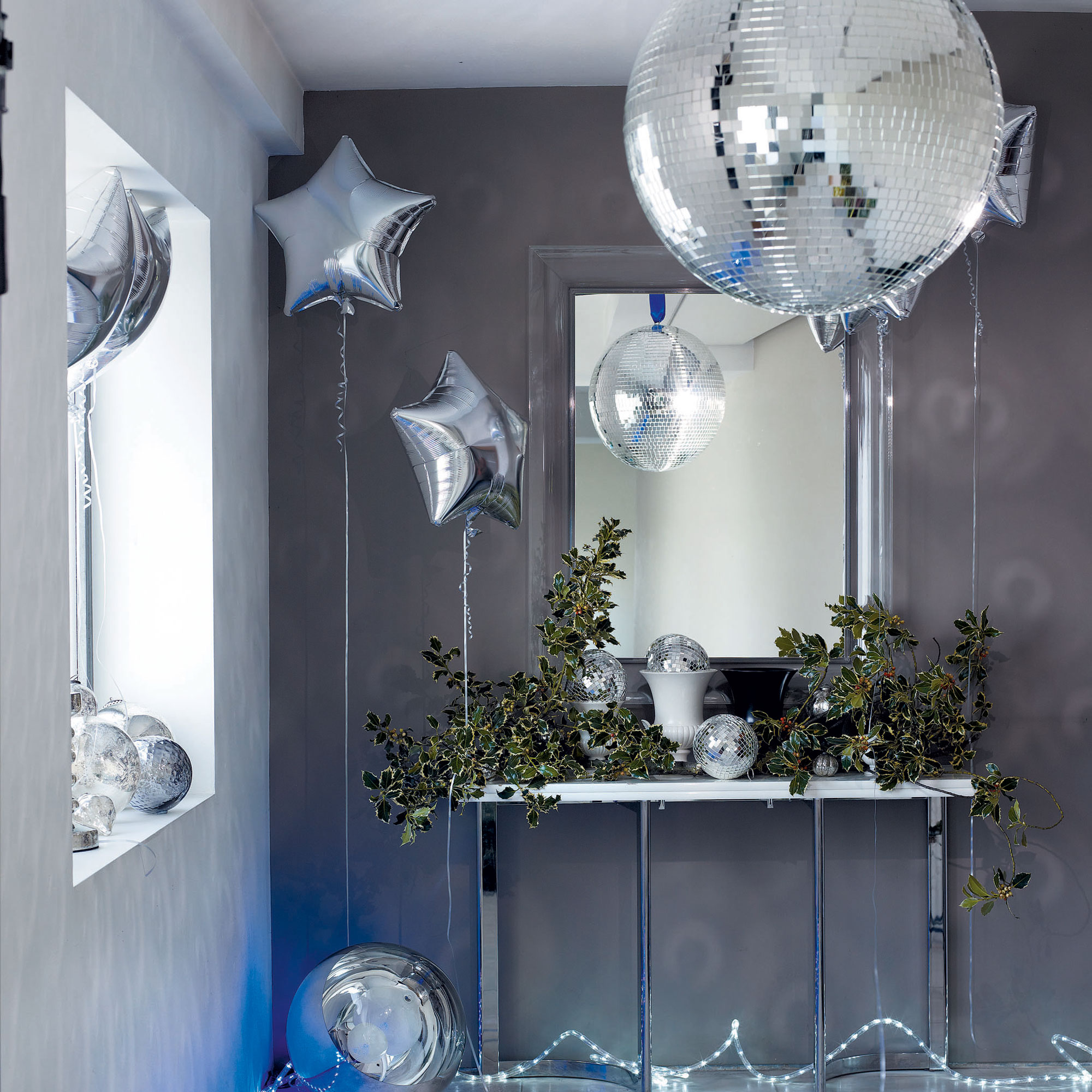 Grey walls with white gloss console table and silver helium balloon