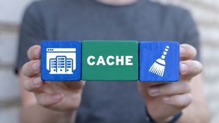 person holding blocks with one labeled cache