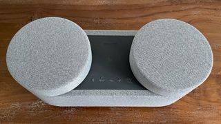 Sony HT-AX7 wireless speaker from above with surround speakers attached on wooden surface