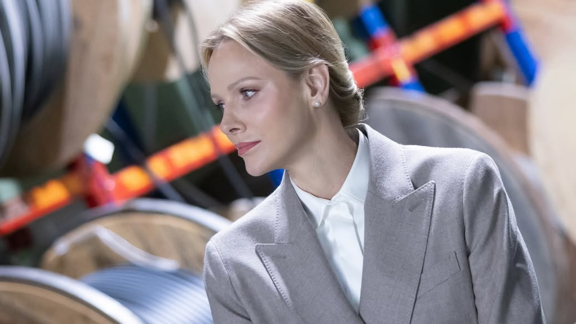 Princess Charlene wearing a blazer folding her arms