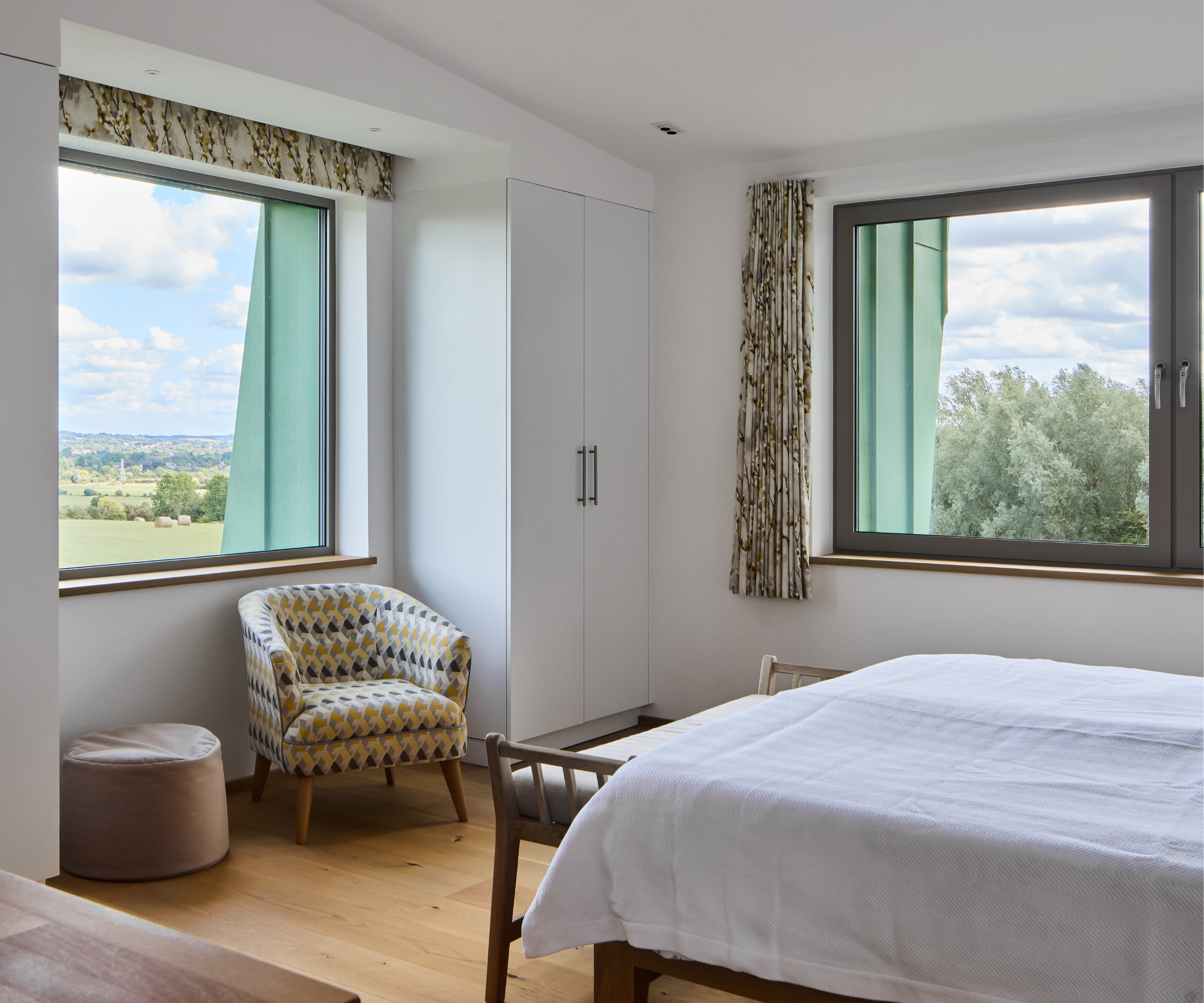 Bedroom with window in front of and to the right hand side of the bed