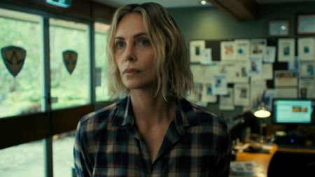 Charlize Theron looking slihgtly concerned in Apex. 